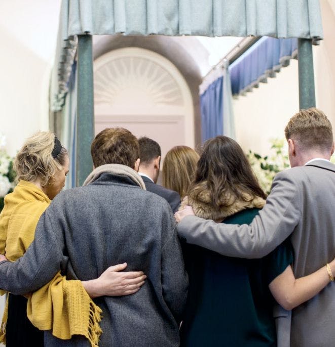 People huddled together in a church after a funeral. | Wrongful Death | The Sullivan Law Firm